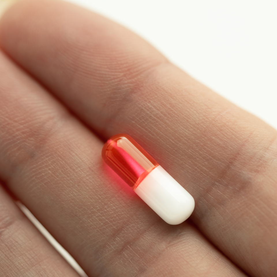 Tongue barbell with colored pill