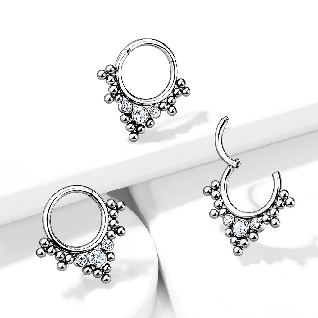 Hinged ring made of titanium with clustered beads and stones